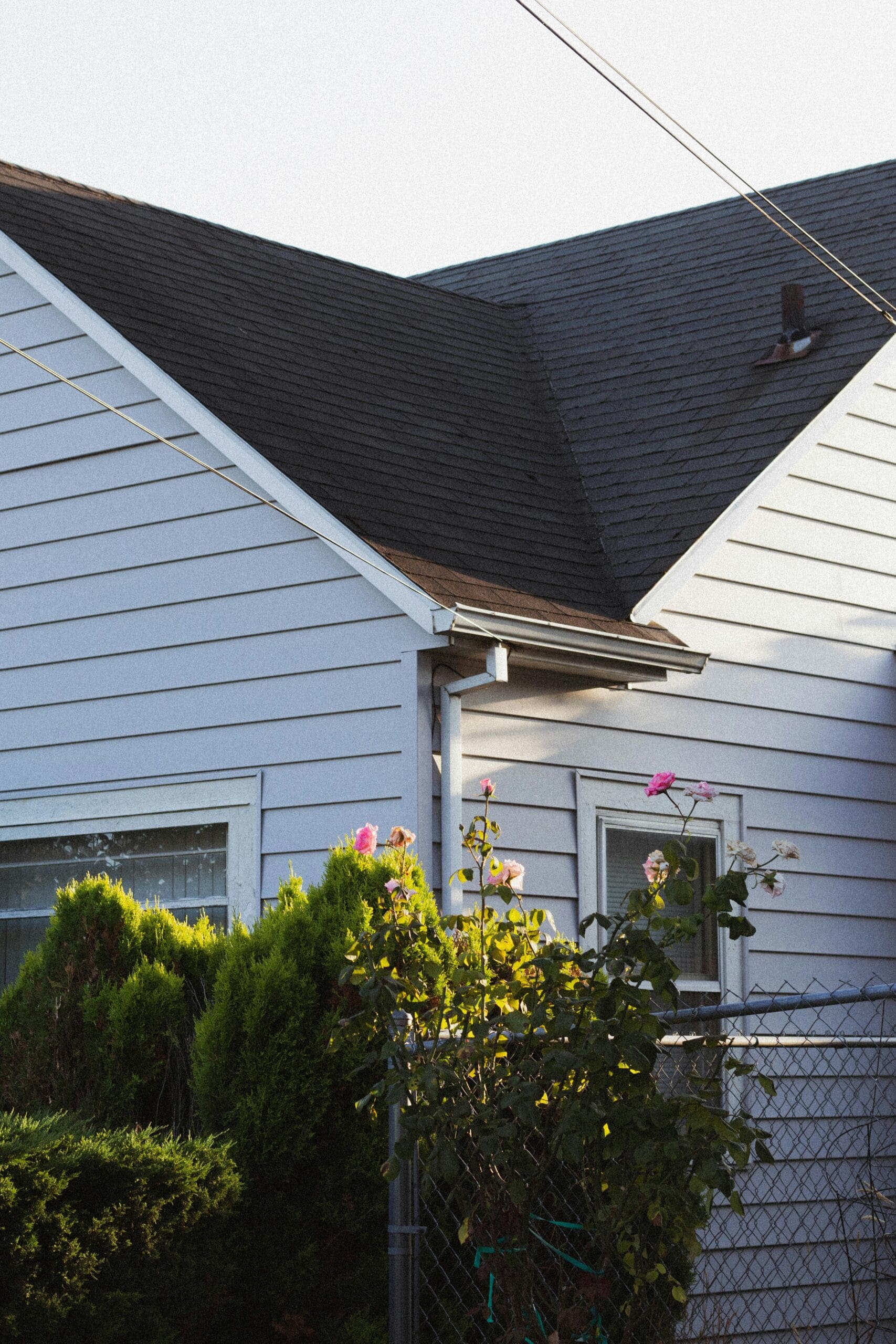 Asphalt shingle roof on residential home in Northern Utah with clean roof lines and siding